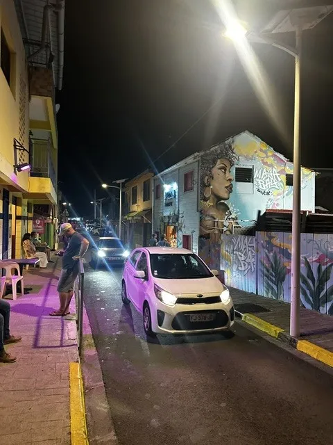 Colourful island street with murals at night